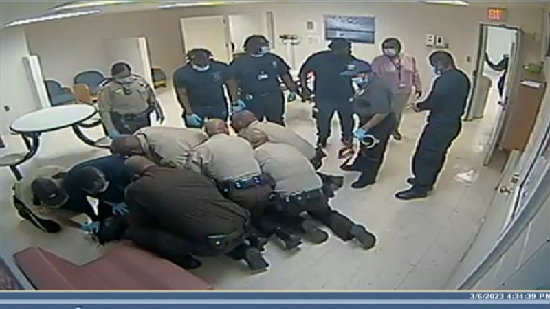 Video shows the man being pinned to the floor before he died