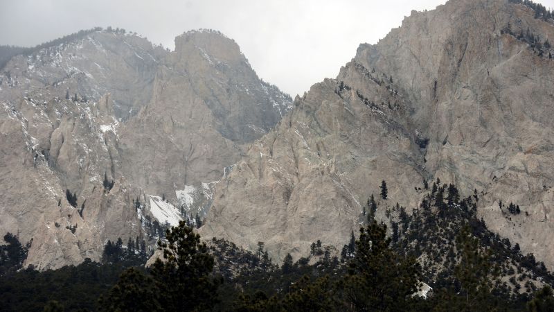 Officials say a man sits in a hot tub with a mountain lion